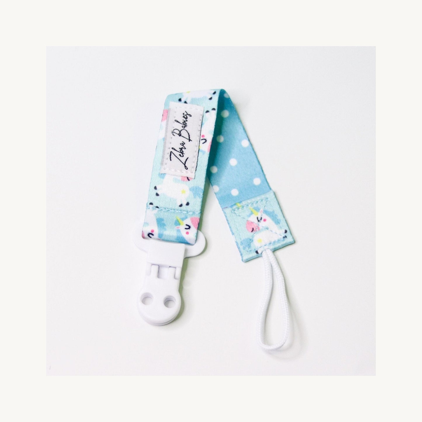 FlexiRibbon Dummy Clip Baby Unicorns – children's product by Zebra Babies | Aster & Ruby